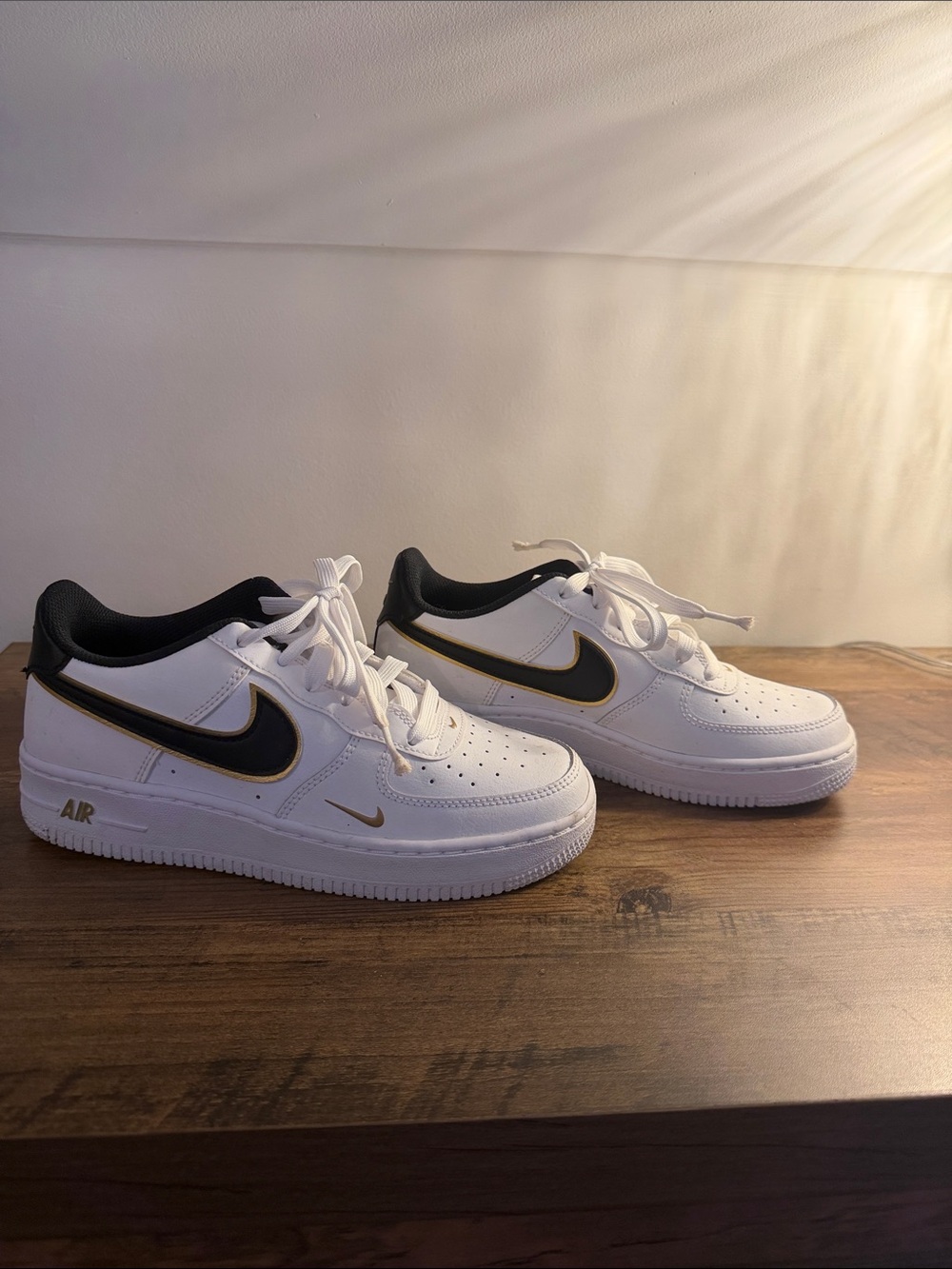 Nike Air Force 1s Black and Gold